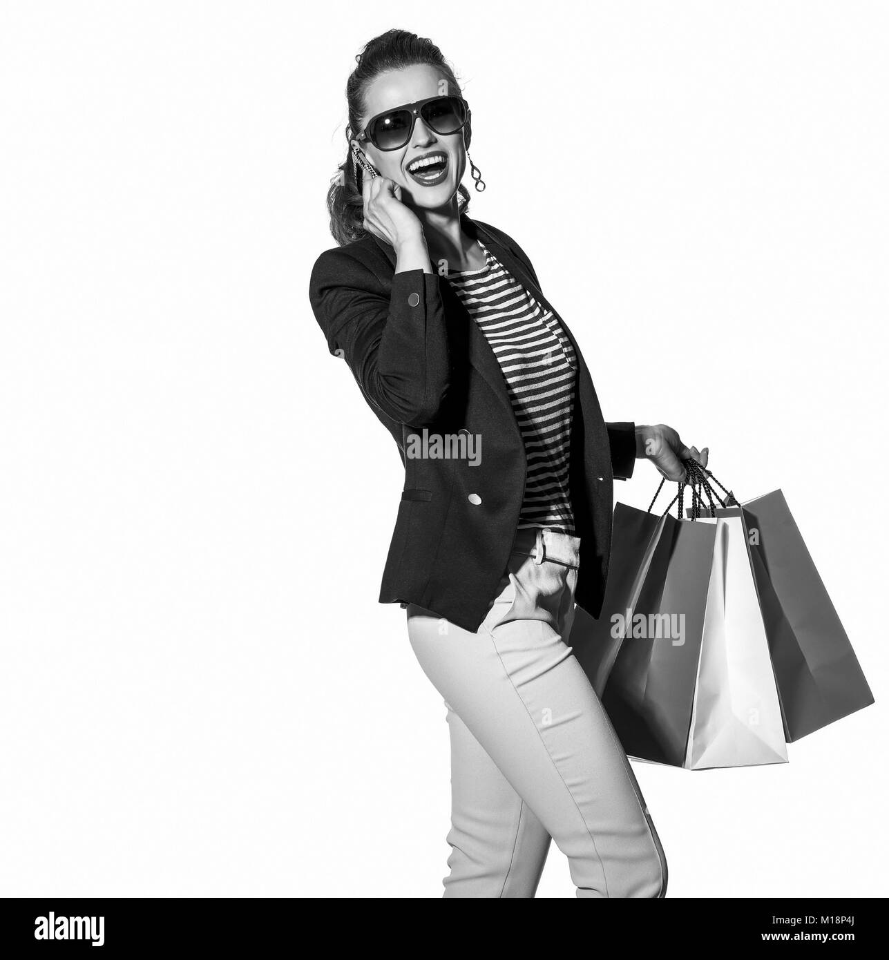 Luxury Shopping. The French way. Full length portrait of happy young woman with shopping bags in