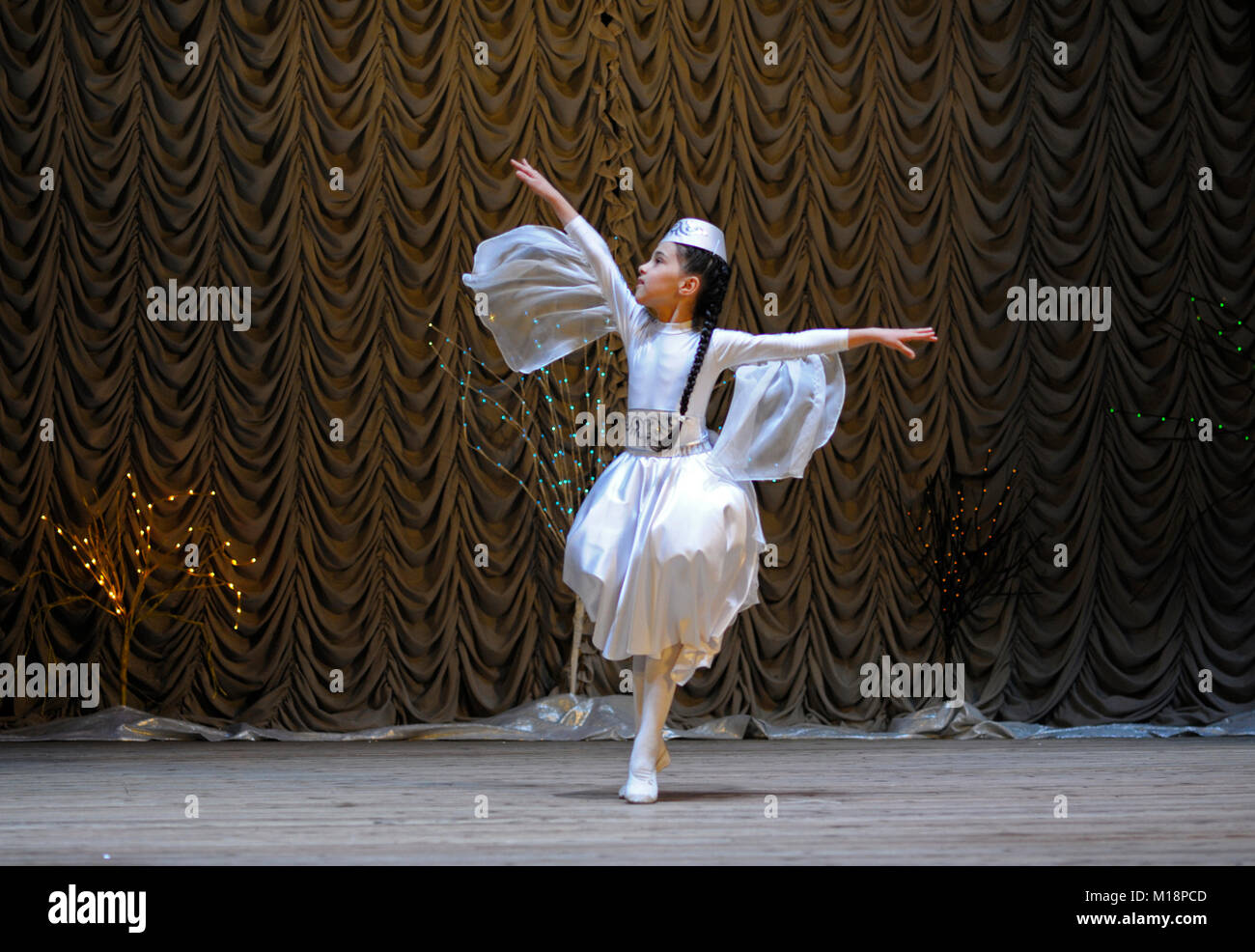 Crimean tatar baby girl in a native dress performing native dance on stage. Celebrating nowruz (Turkic New Year) . December 24, 2017. Kyiv, Ukraine Stock Photo