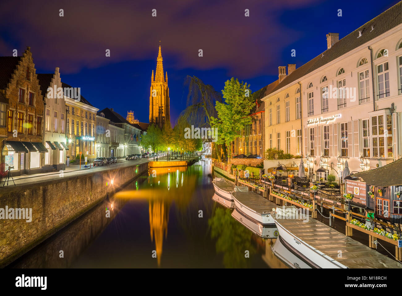 Bruges, Belgium - April 17, 2017: Dijver Canal and the Our Lady Church of Bruges, Belgium. Stock Photo