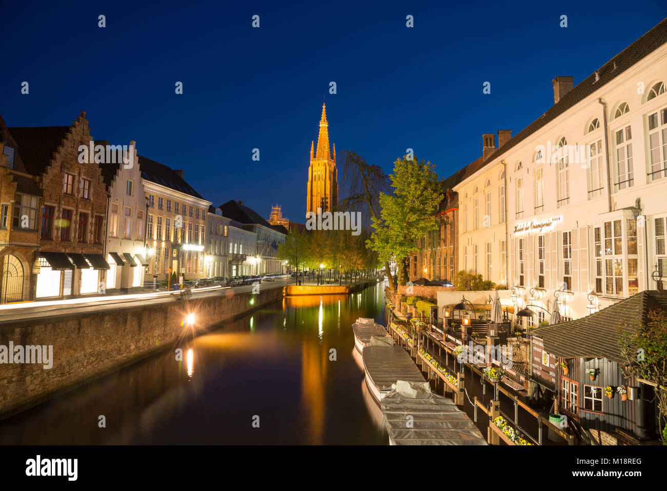 Bruges, Belgium - April 18, 2017: Dijver Canal and the Our Lady Church of Bruges, Belgium. Stock Photo