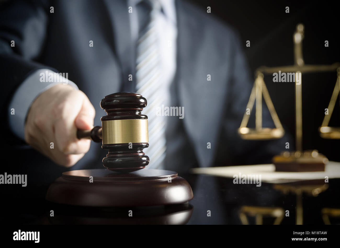 Lawyer or attorney works in his office. Wooden gavel in hand Stock Photo