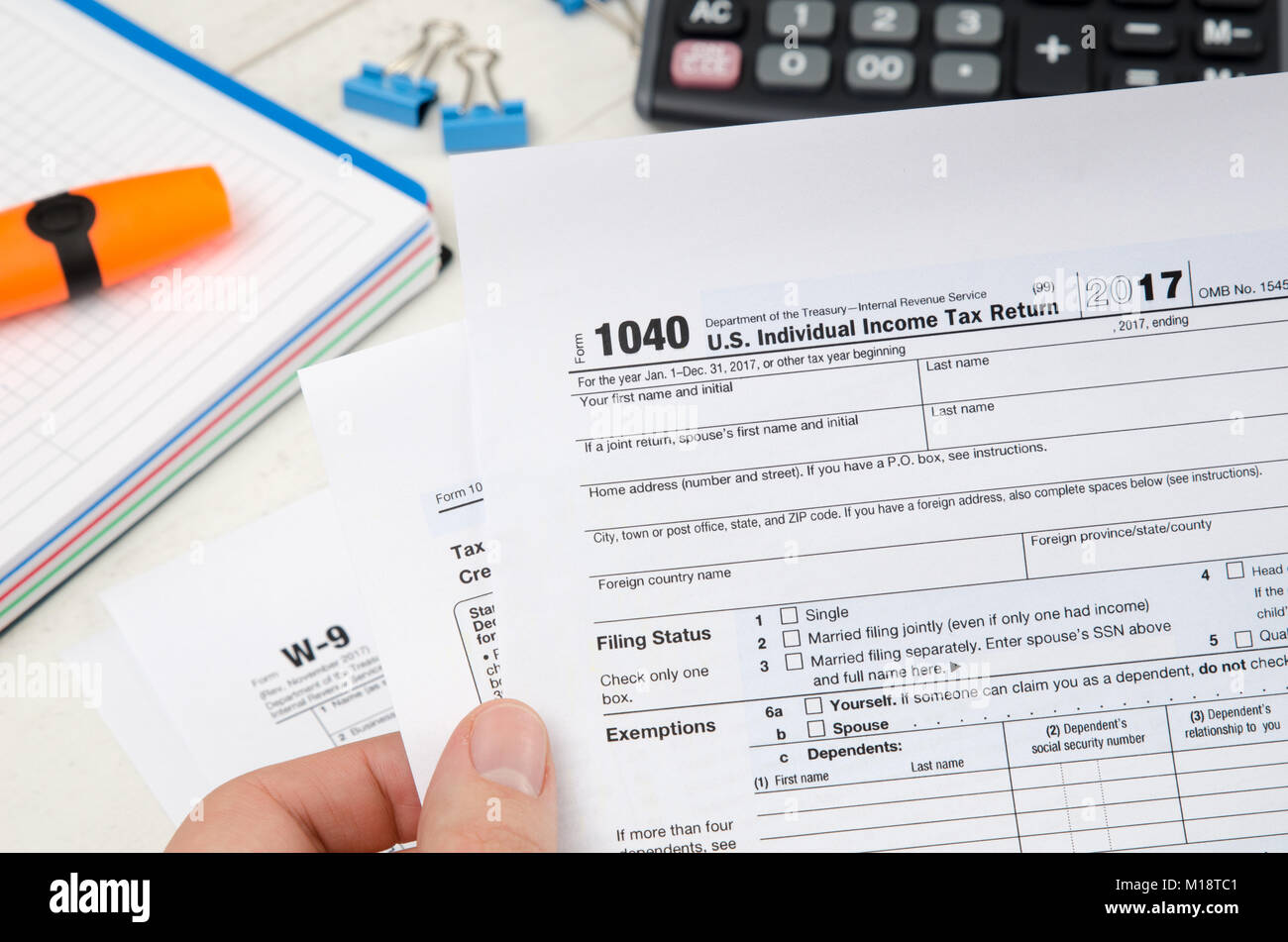 Man holding US tax form 1040. Tax form law document irs business concept Stock Photo
