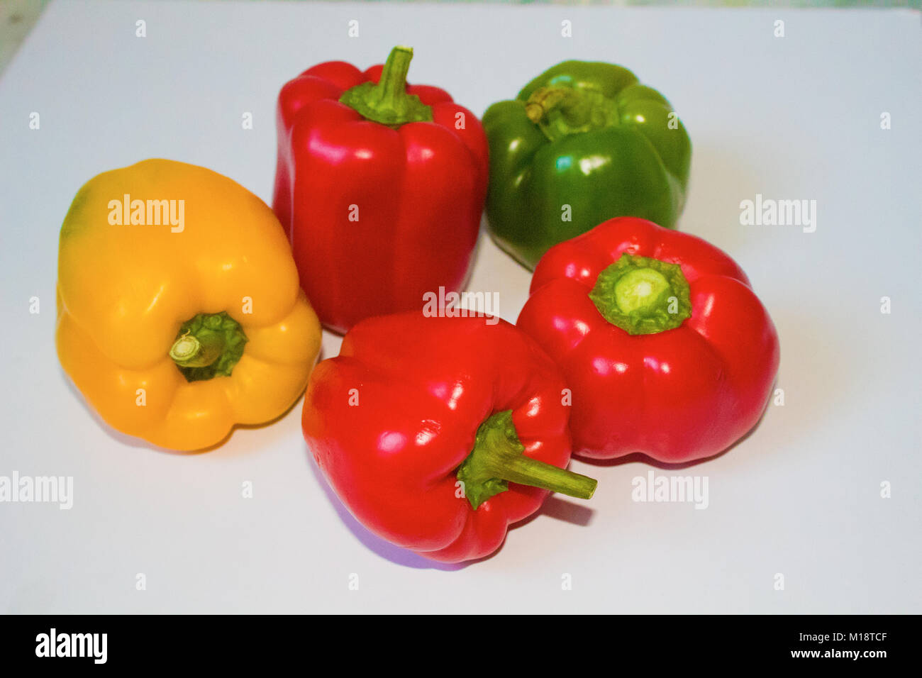 red and yellow and green sweet peppers in white background Stock Photo ...