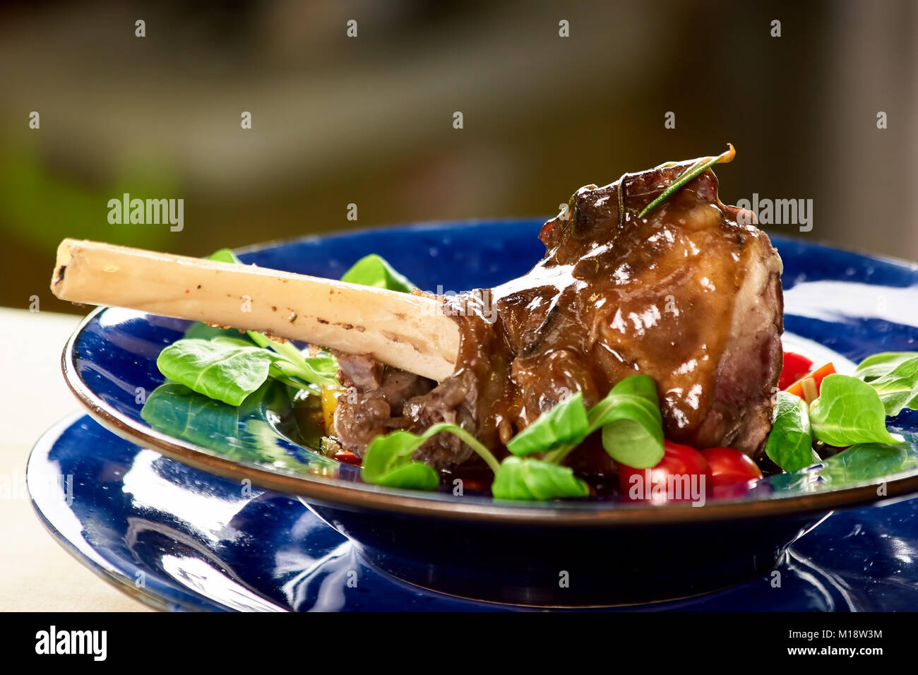 Roasted lamb leg with sauce and side dish Stock Photo Alamy