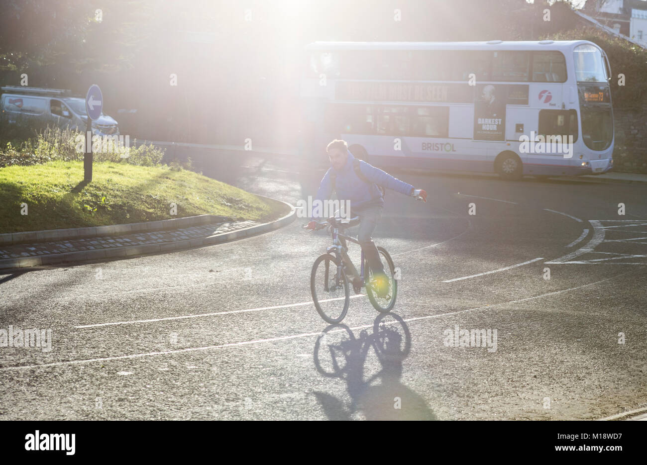 a-cyclist-gives-a-hand-signal-whilst-turning-off-a-roundabout-bristol