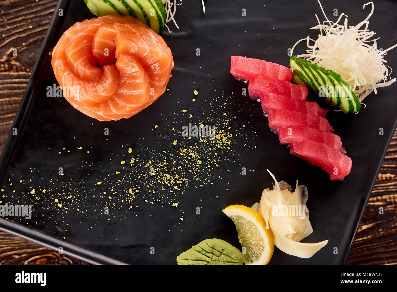 Rolled fresh salmon and tuna sliced pieces closeup. Stock Photo