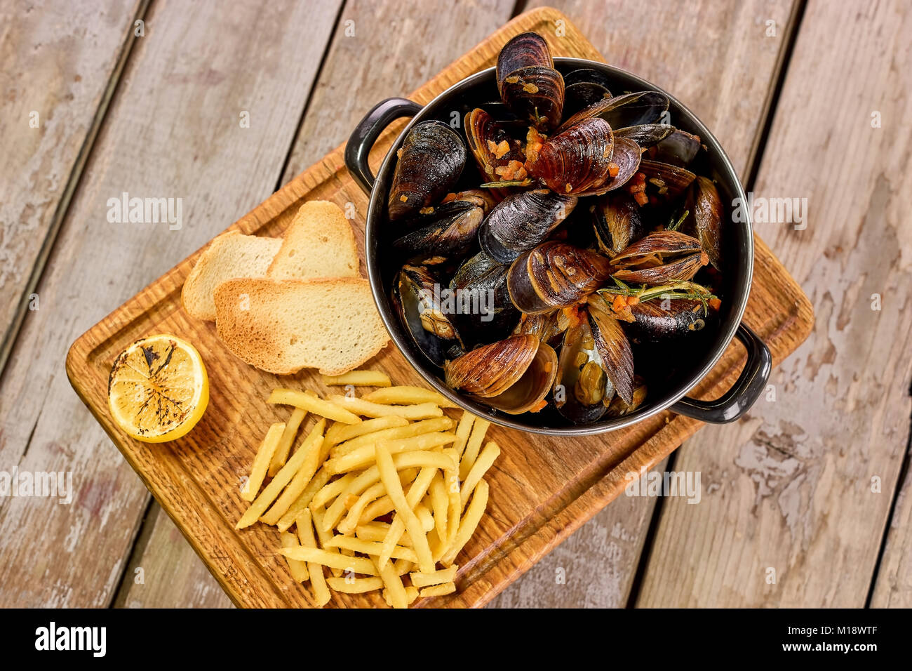 Many mussels in saucepan and side dish Stock Photo Alamy