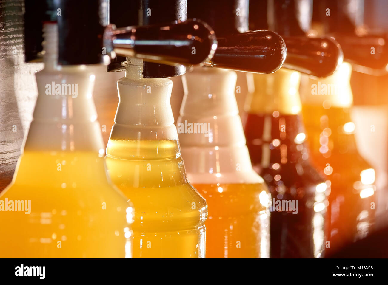 Different beers filling bottles, close up Stock Photo Alamy
