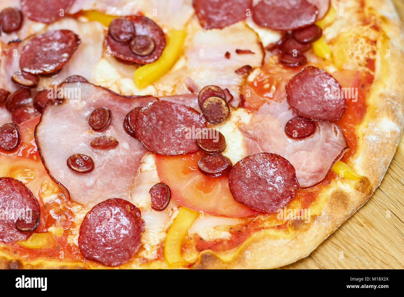 Crispy salami pizza with vegetables, close up Stock Photo Alamy