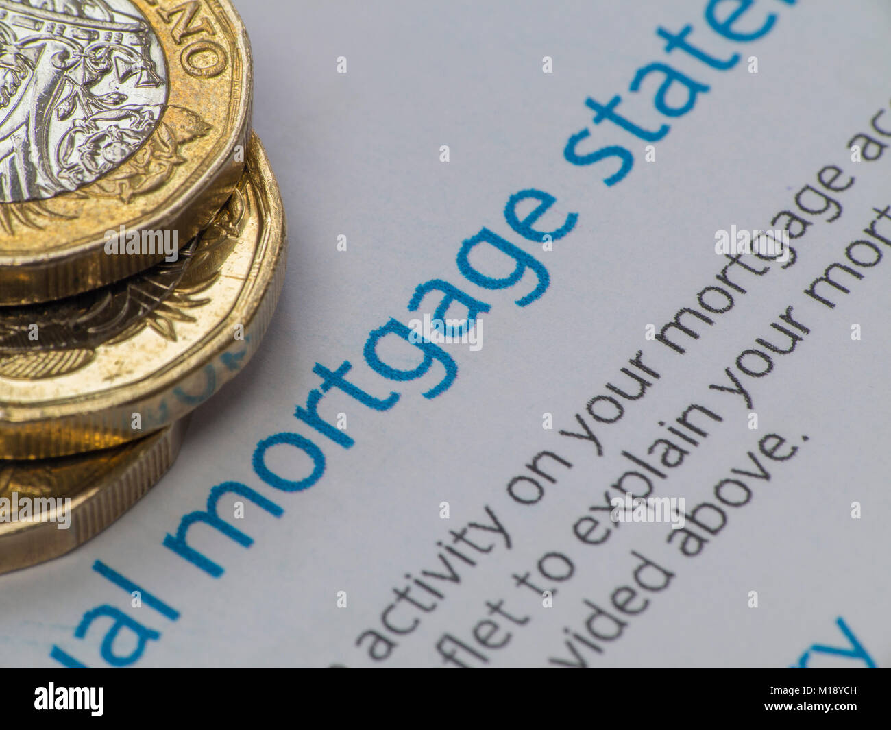 A mortgage statement with some loose change and a house key Stock Photo