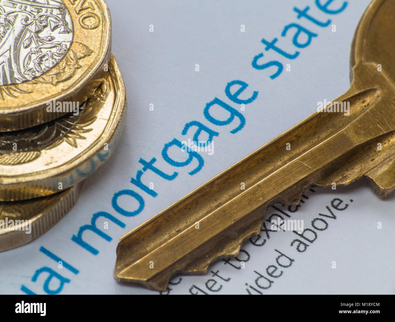 A mortgage statement with some loose change and a house key Stock Photo
