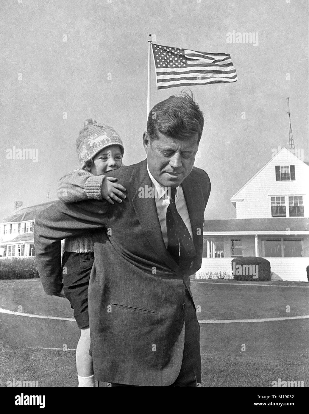 John F. Kennedy gives daughter Caroline Kennedy a piggy back ride, Hyannis Port, Massachusetts. November 9, 1960, The day after his election as president Stock Photo