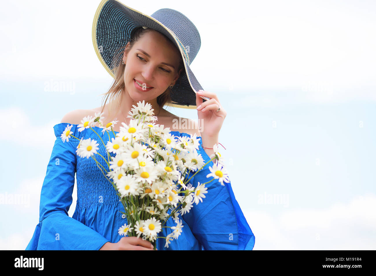 Young cute girl in a hat in a field at sunset Stock Photo - Alamy