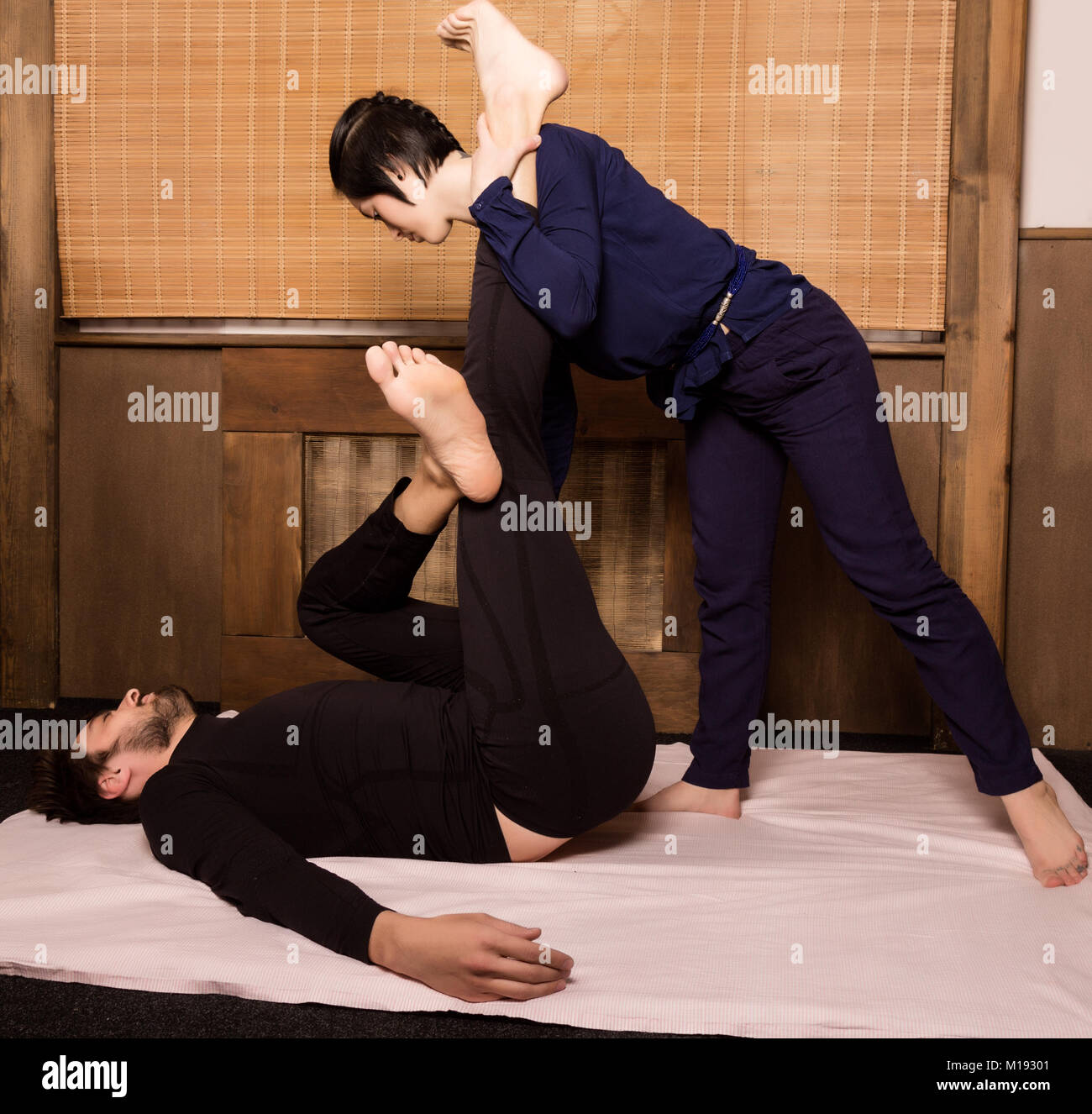 Foot massage in thai studio. Professional therapist giving traditional