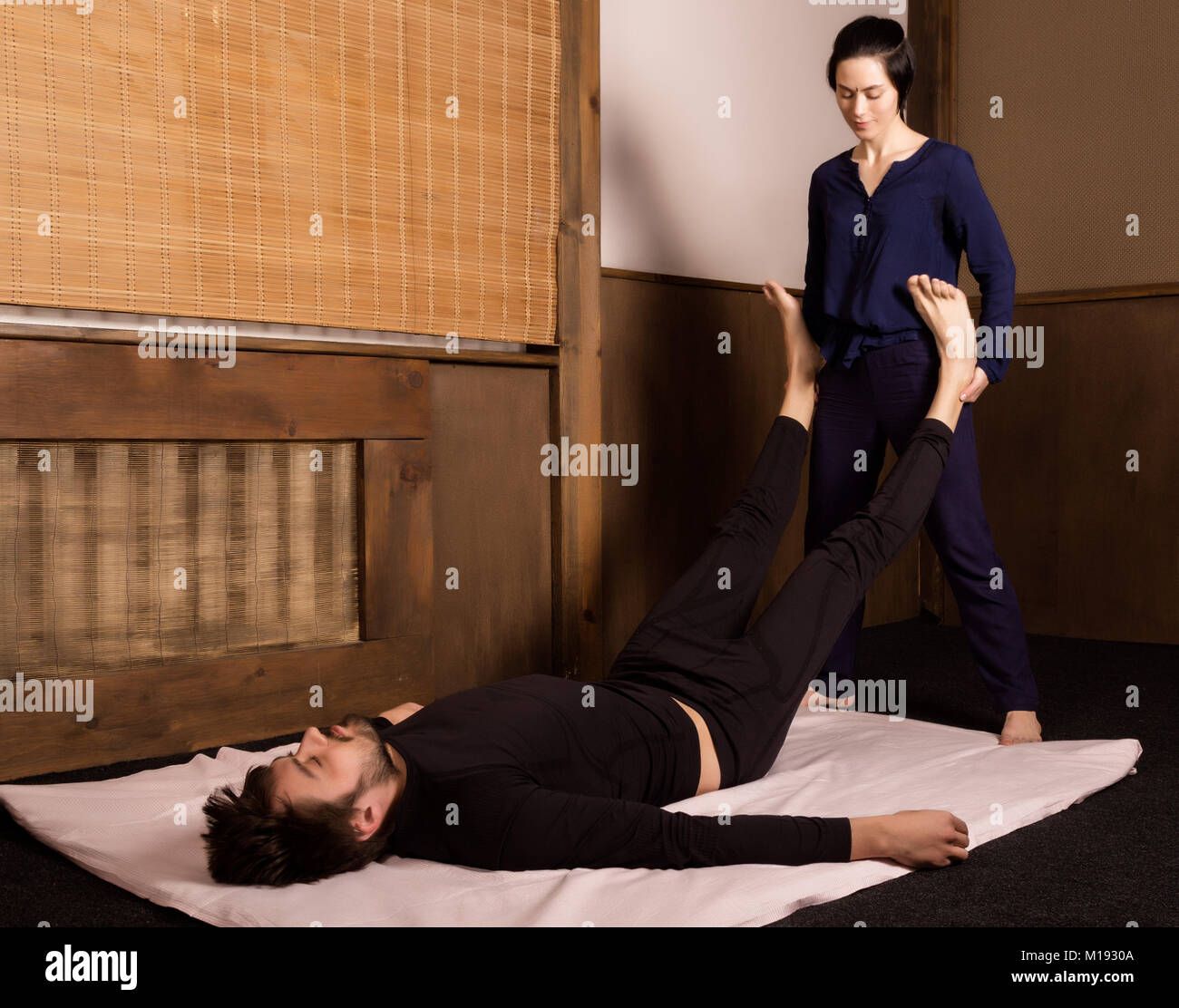 Foot massage in thai studio. Professional therapist giving traditional