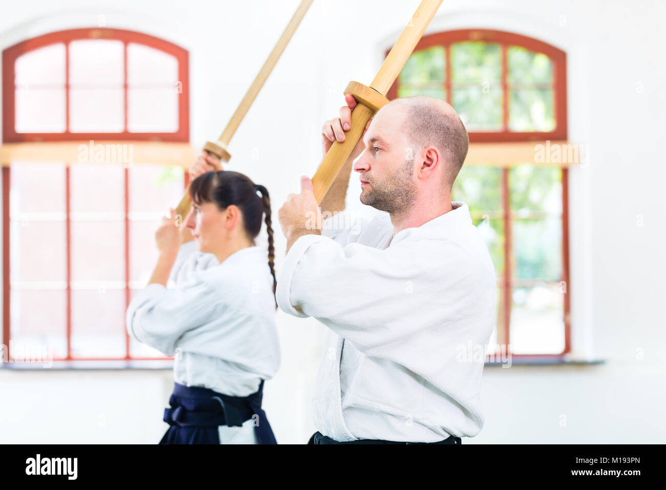 Man and woman having Aikido sword fight Stock Photo