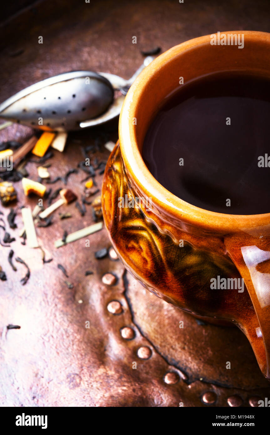 Clay cup with herbal tea on a vintage background Stock Photo