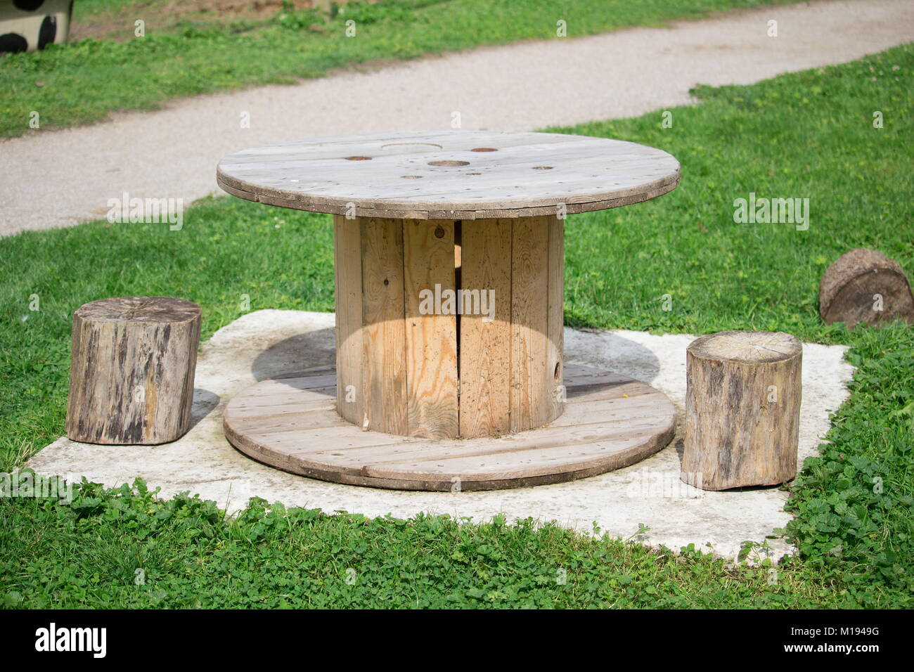 a Picnic table and wooden logs to serve as a chair Stock Photo