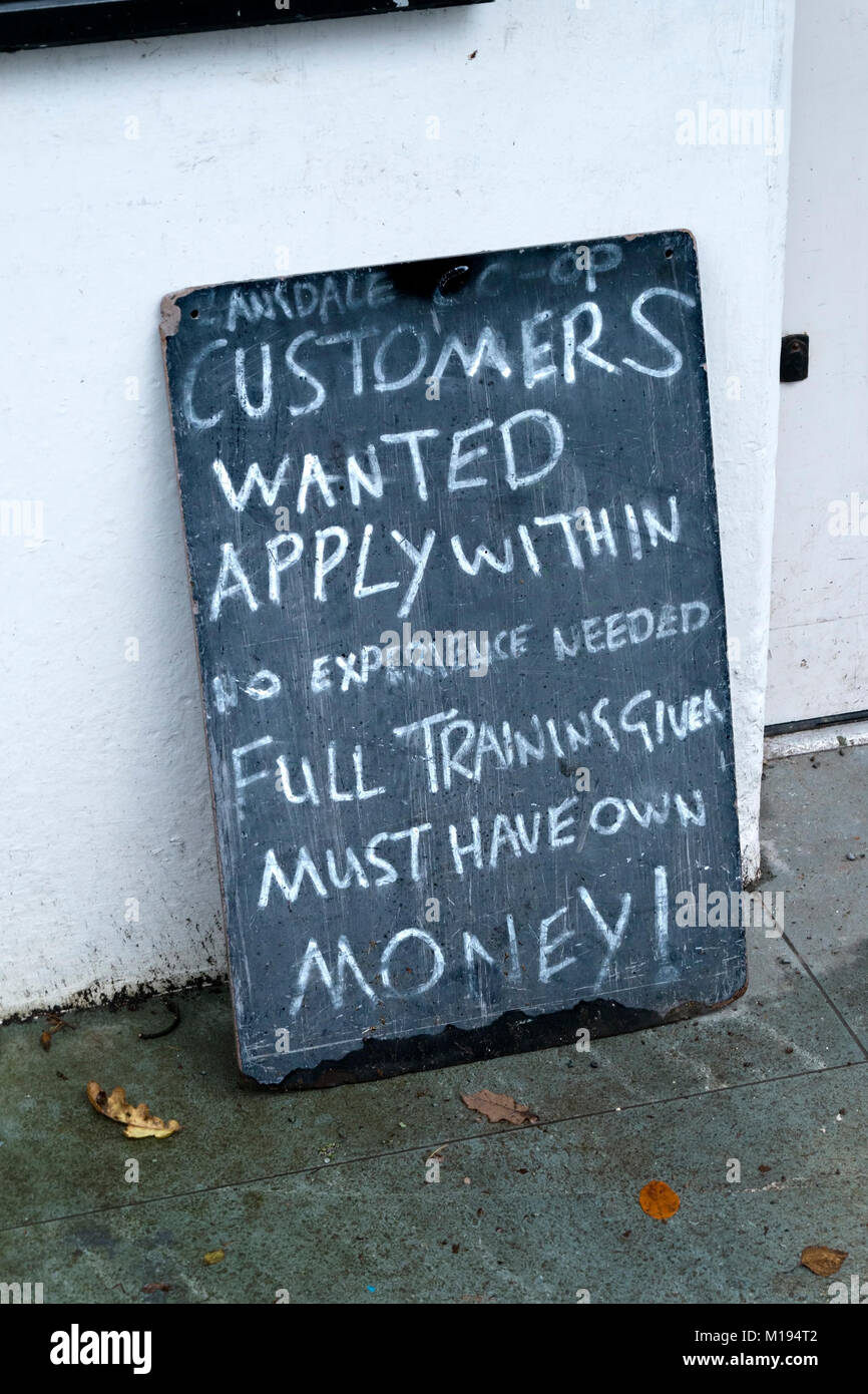 Amusing 'customers wanted' shop sign, Chapel Stile village store, Langdale, Cumbria, England, UK Stock Photo