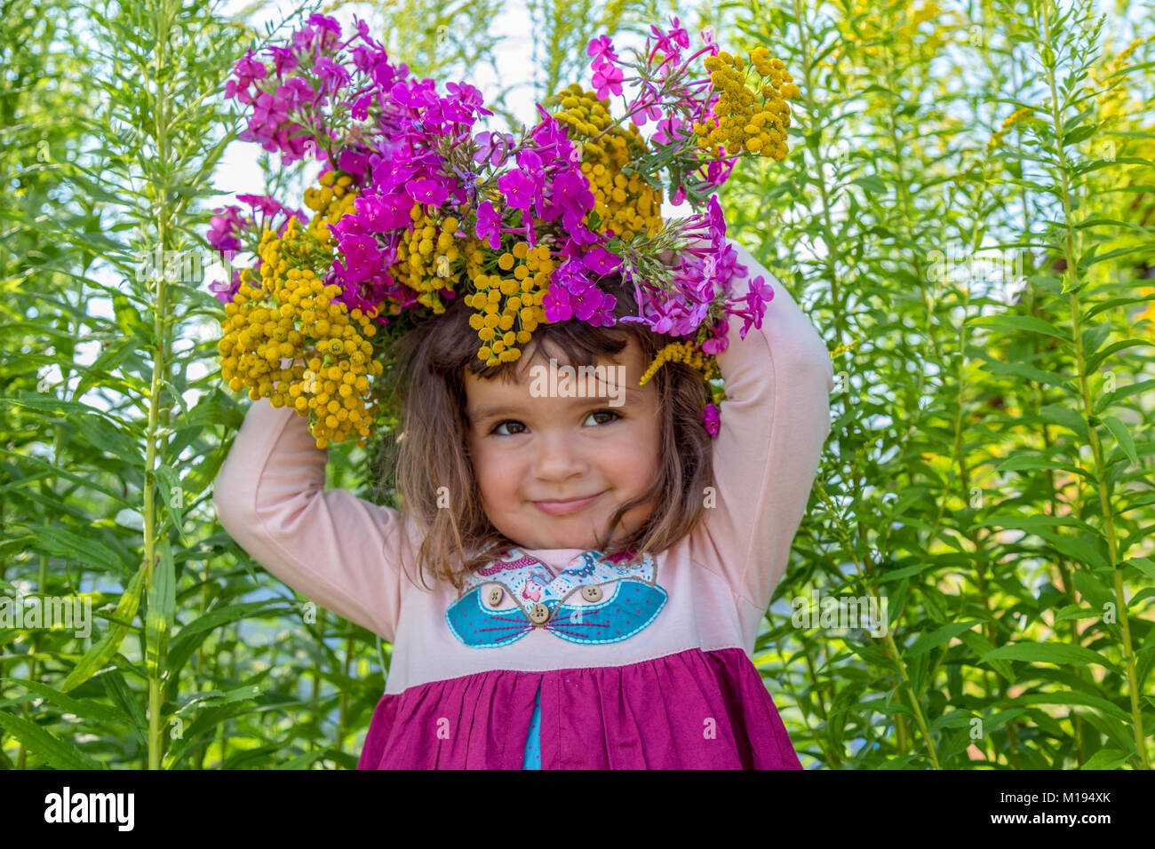 Girl playing on the flower field Stock Photo - Alamy