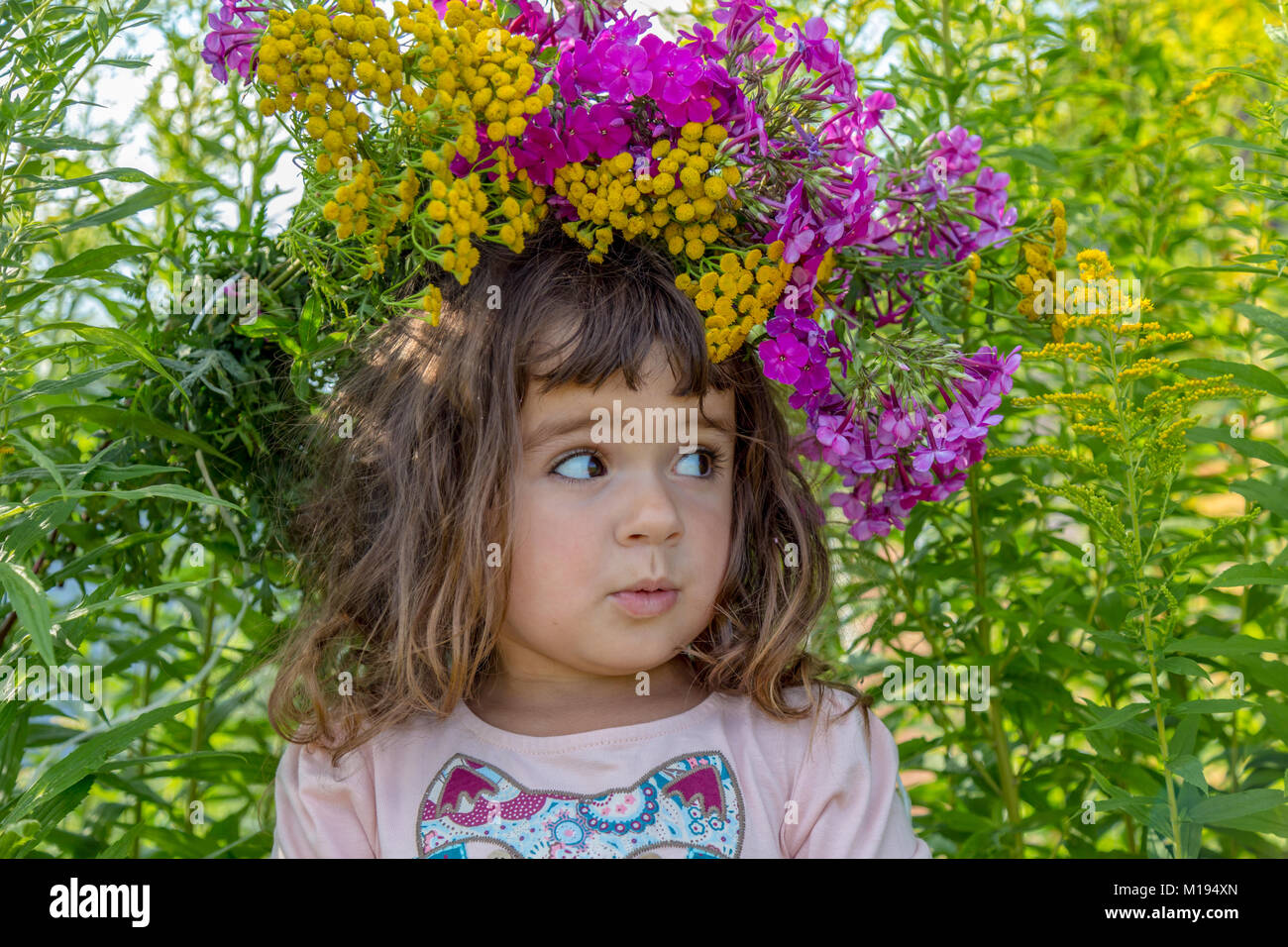 Girl playing on the flower field Stock Photo - Alamy