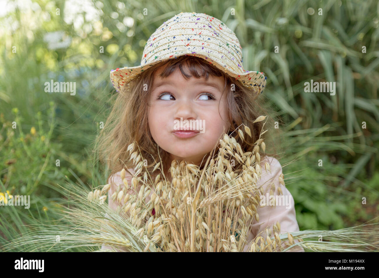 Girl playing on the flower field Stock Photo - Alamy