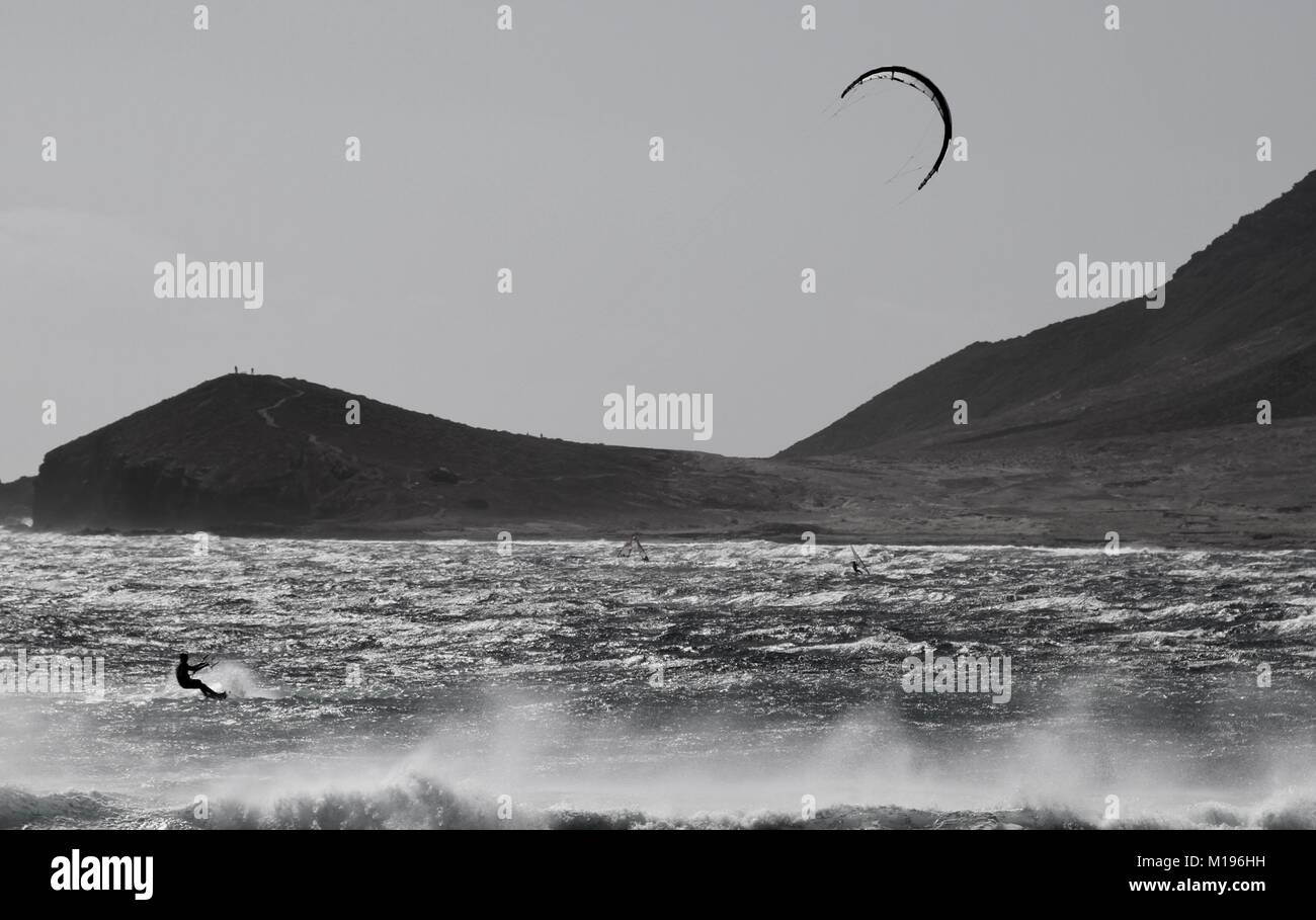 Kitesurfer El Medano Tenerife on a windy day, with a mountain in the background. Holiday destination for water sport users. Photo by Nikki Attree Stock Photo