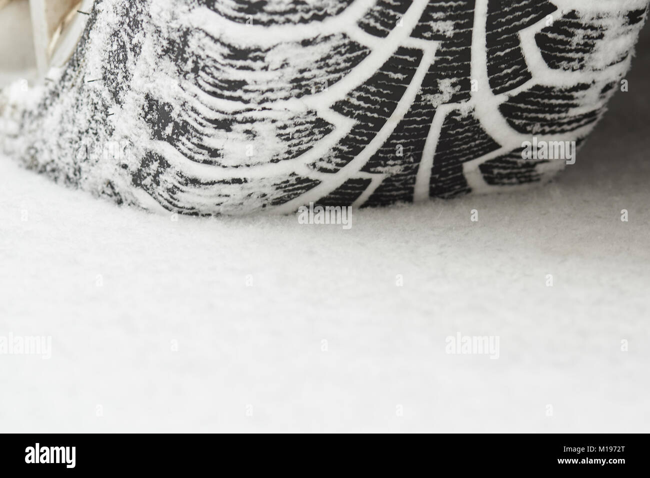 Car winter tire with snow close up view. Driving at winter time Stock Photo