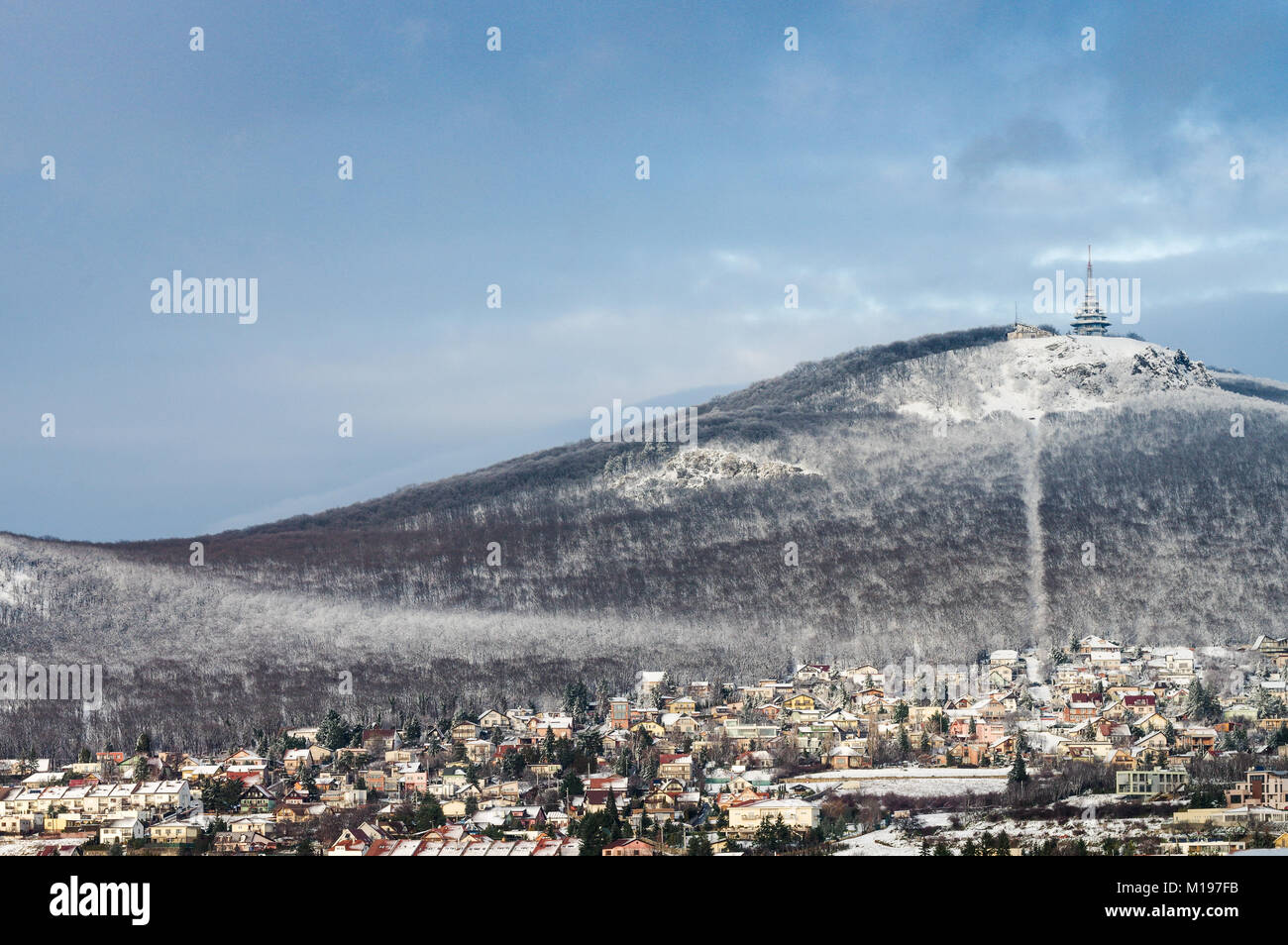 Snow-covered Zobor Hill overlooking the Slovak city Nitra on a bright, sunny winter day Stock Photo