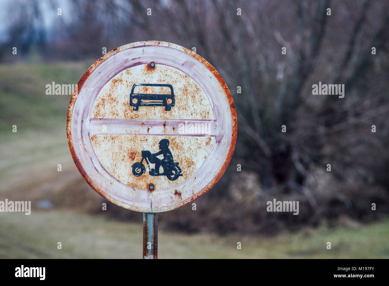 Rusty old 'no cars and motorbikes' road sign in southern Slovakia Stock Photo