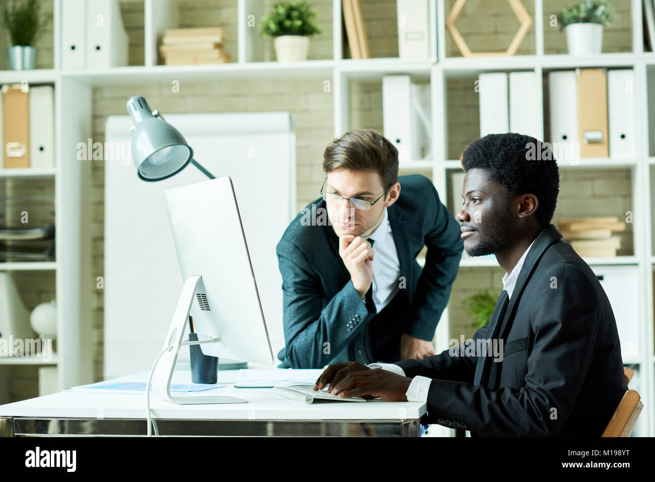 Two Business Professionals using Computer Stock Photo - Alamy