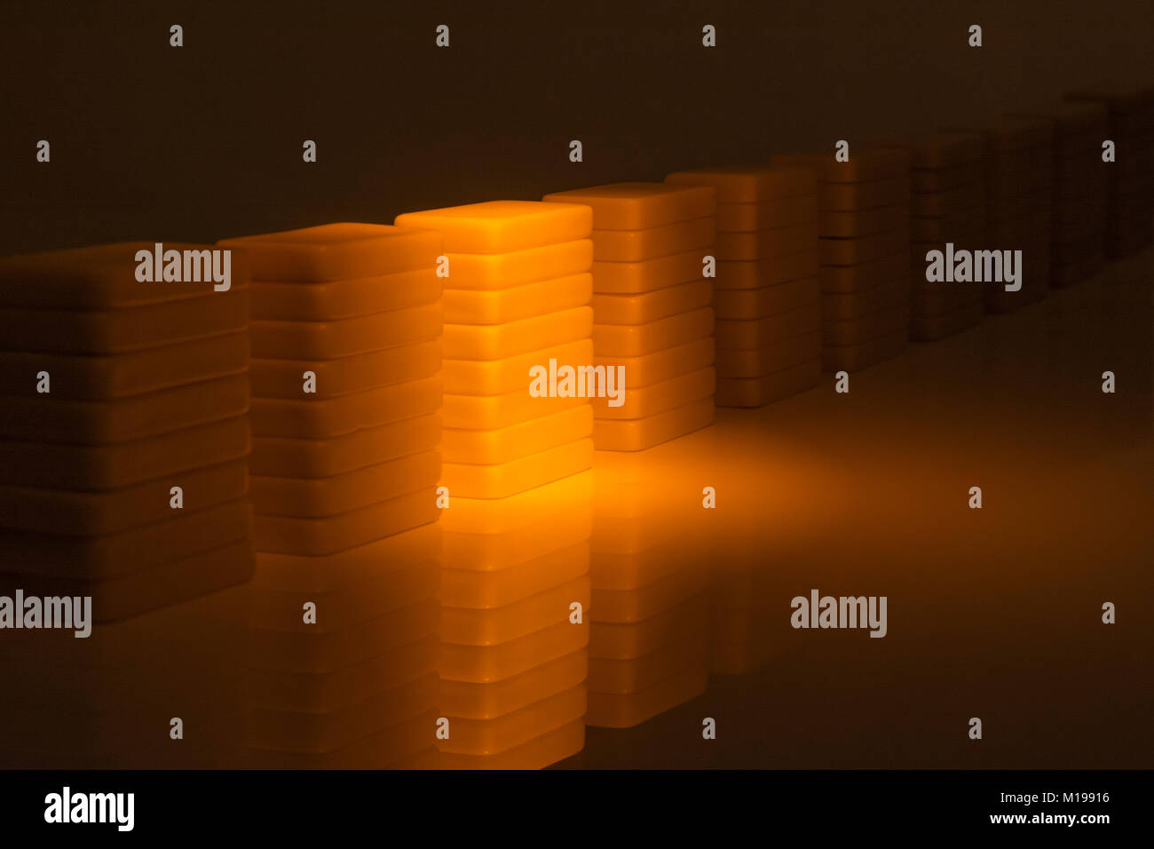 Dominoes on reflective surface. Metaphor for concept of data storage, server farm, or server farm abstract. Data collection abstract, abstract data. Stock Photo