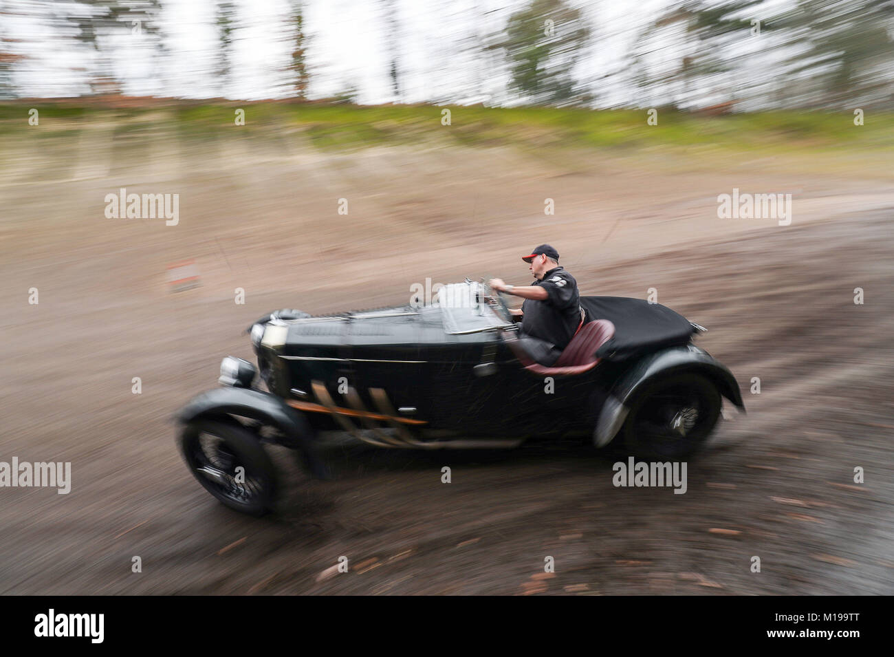 A competitor drives along a section of the old Brooklands track as they take part in the Vintage Sports-Car Club annual driving test day at Brooklands Museum in Surrey. Stock Photo