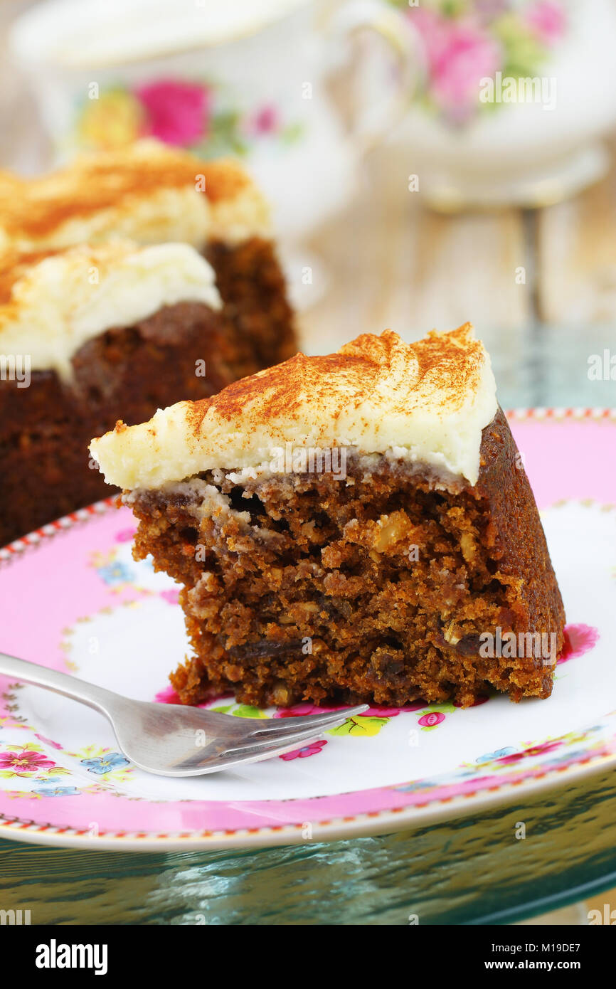 Piece of delicious walnut and carrot cake with marzepain icing on colorful plate Stock Photo