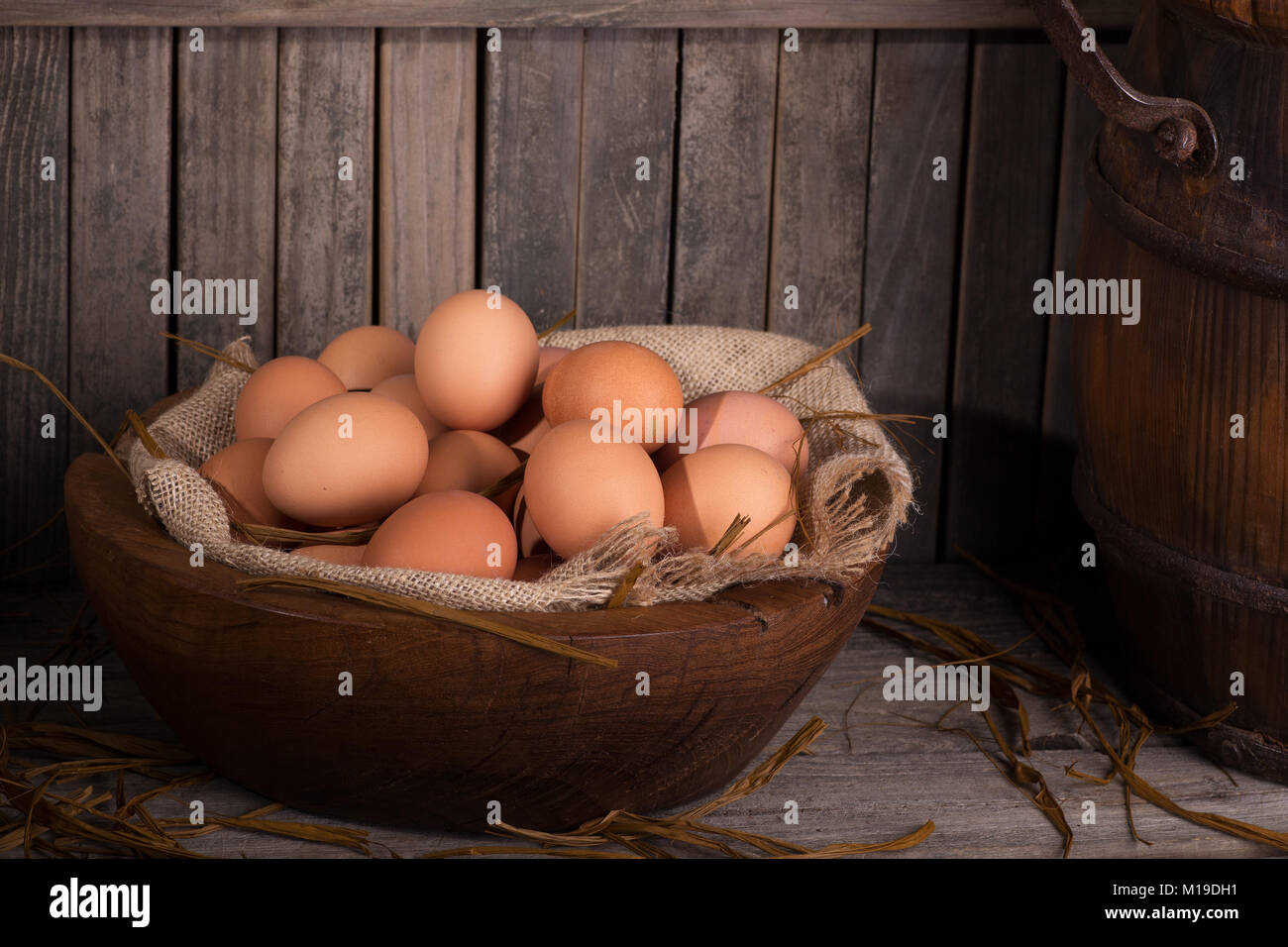 Brown chicken eggs in a wooden bowl with rustic background Stock Photo ...