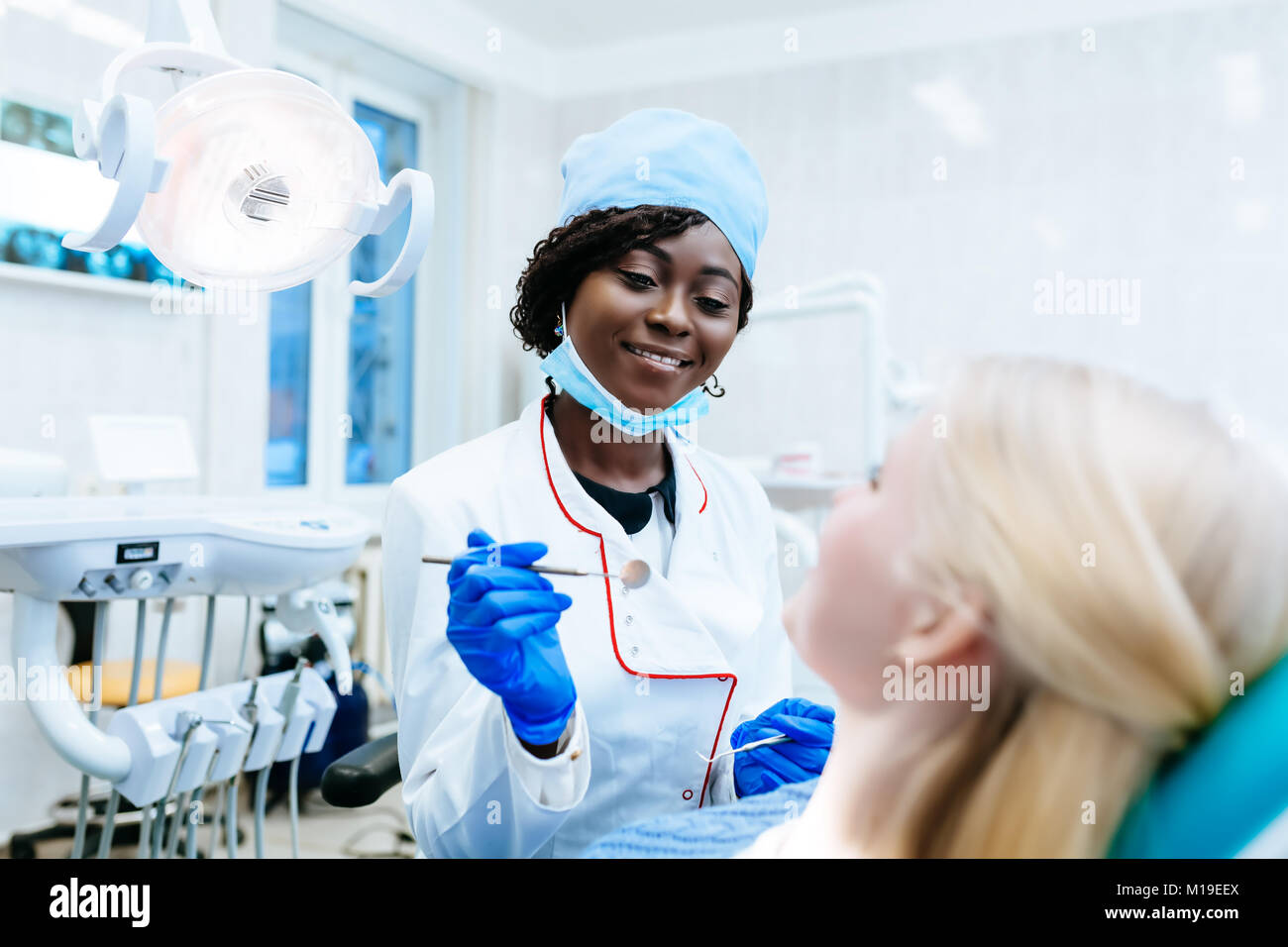 African american female dentist treating patient at clinic Stock Photo Alamy