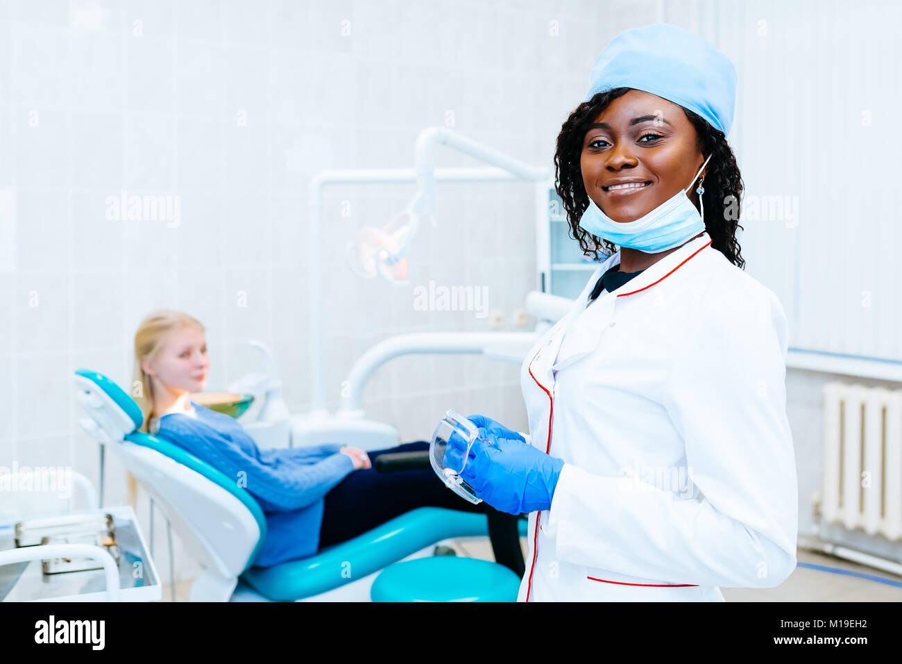 African american female dentist treating patient at clinic Stock Photo Alamy