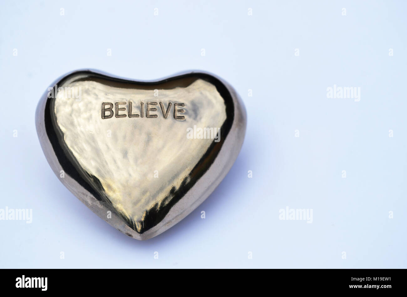 Believe in your heart silver chrome on white background Stock Photo