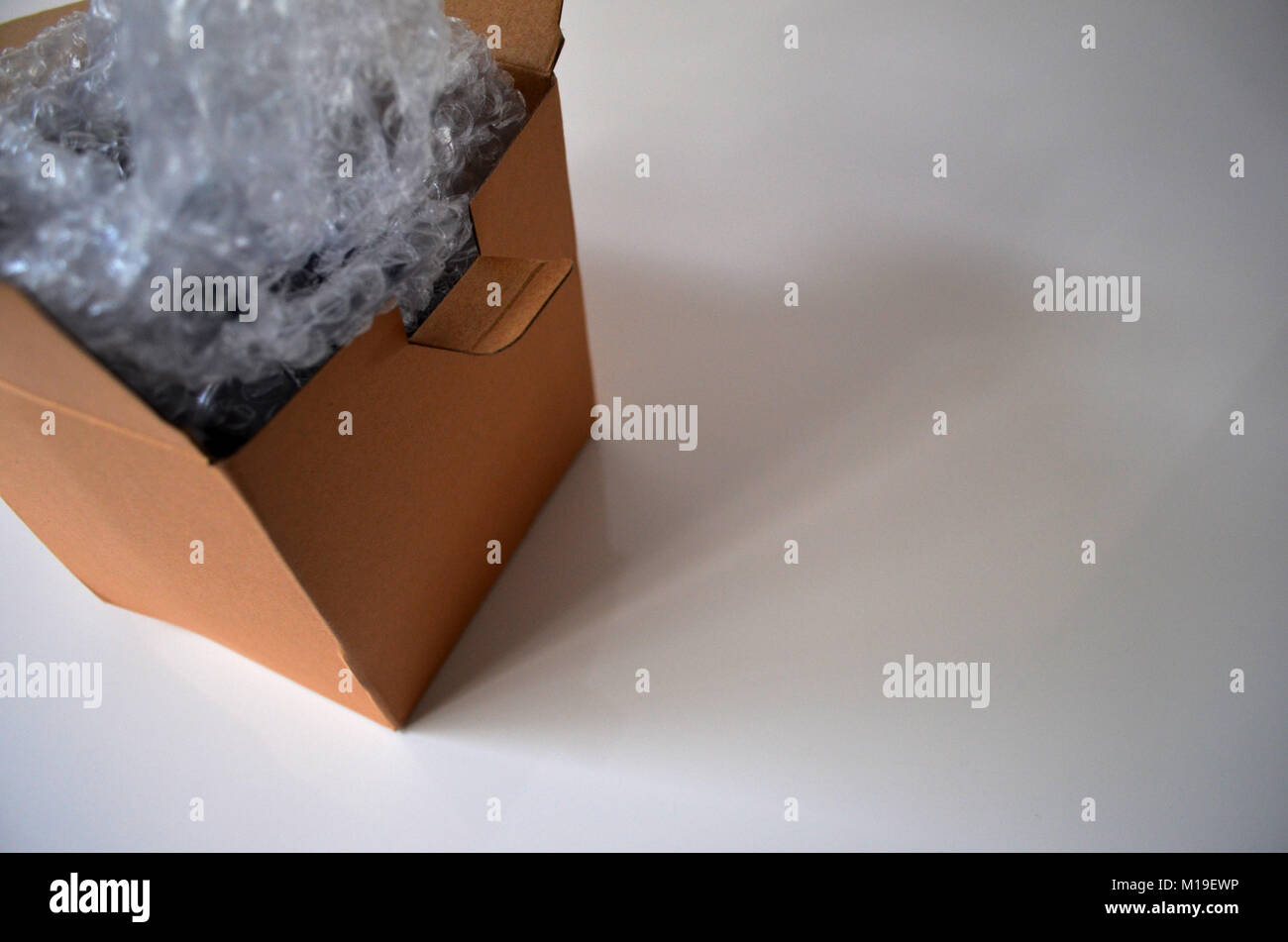 Open cardboard box with bubble wrap Stock Photo Alamy