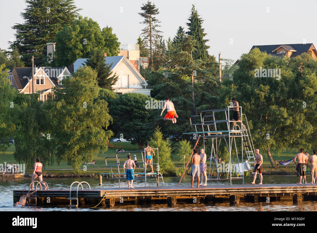 Diving from float in Green Lake, Seattle, Washington, USA Stock Photo