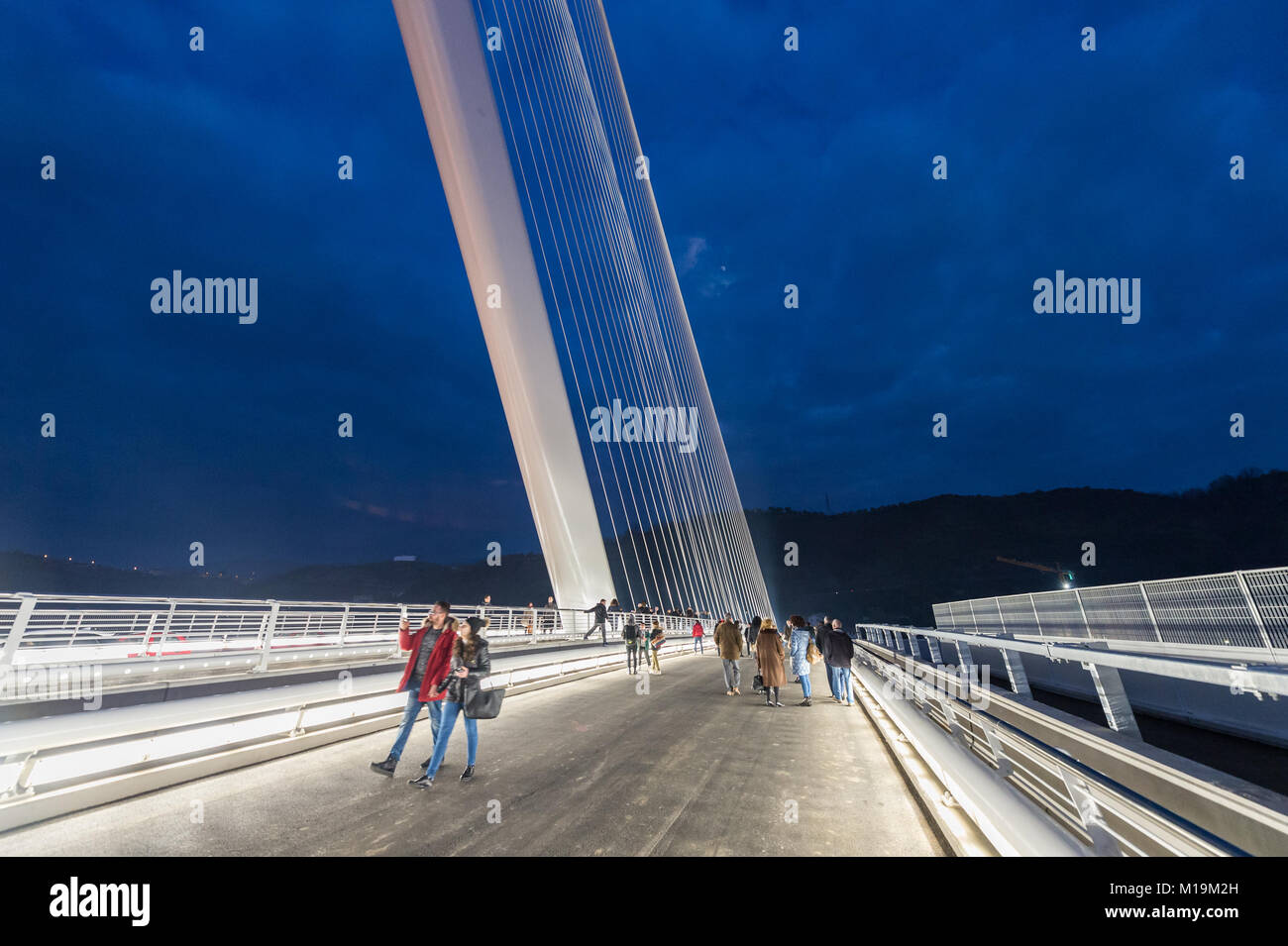 Cosenza, a night view of the new bridge bridge built in Cosenza, designed by architect and engineer Santiago Calatrava, named after San Francesco di Paola, the patron saint of Calabria. The bridge was inaugurated on January 27, 2018, and was designed and built in the shape of a harp, it is 104 meters tall, has a 130 meter long pylon and is inclined to 52 degrees from which the tie rods depart. around 20 million euros. It is currently considered one of the largest works made in the south. The bridge connects the two banks of the river Crati connecting the district Gergeri with Via Popilia. 28/0 Stock Photo