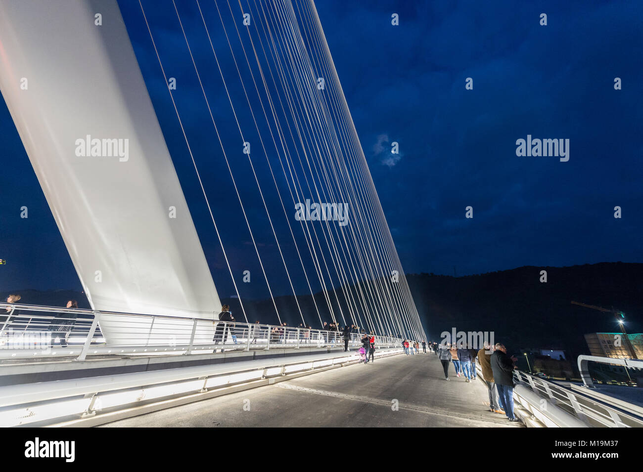 Cosenza, a night view of the new bridge bridge built in Cosenza, designed by architect and engineer Santiago Calatrava, named after San Francesco di Paola, the patron saint of Calabria. The bridge was inaugurated on January 27, 2018, and was designed and built in the shape of a harp, it is 104 meters tall, has a 130 meter long pylon and is inclined to 52 degrees from which the tie rods depart. around 20 million euros. It is currently considered one of the largest works made in the south. The bridge connects the two banks of the river Crati connecting the district Gergeri with Via Popilia. 28/0 Stock Photo