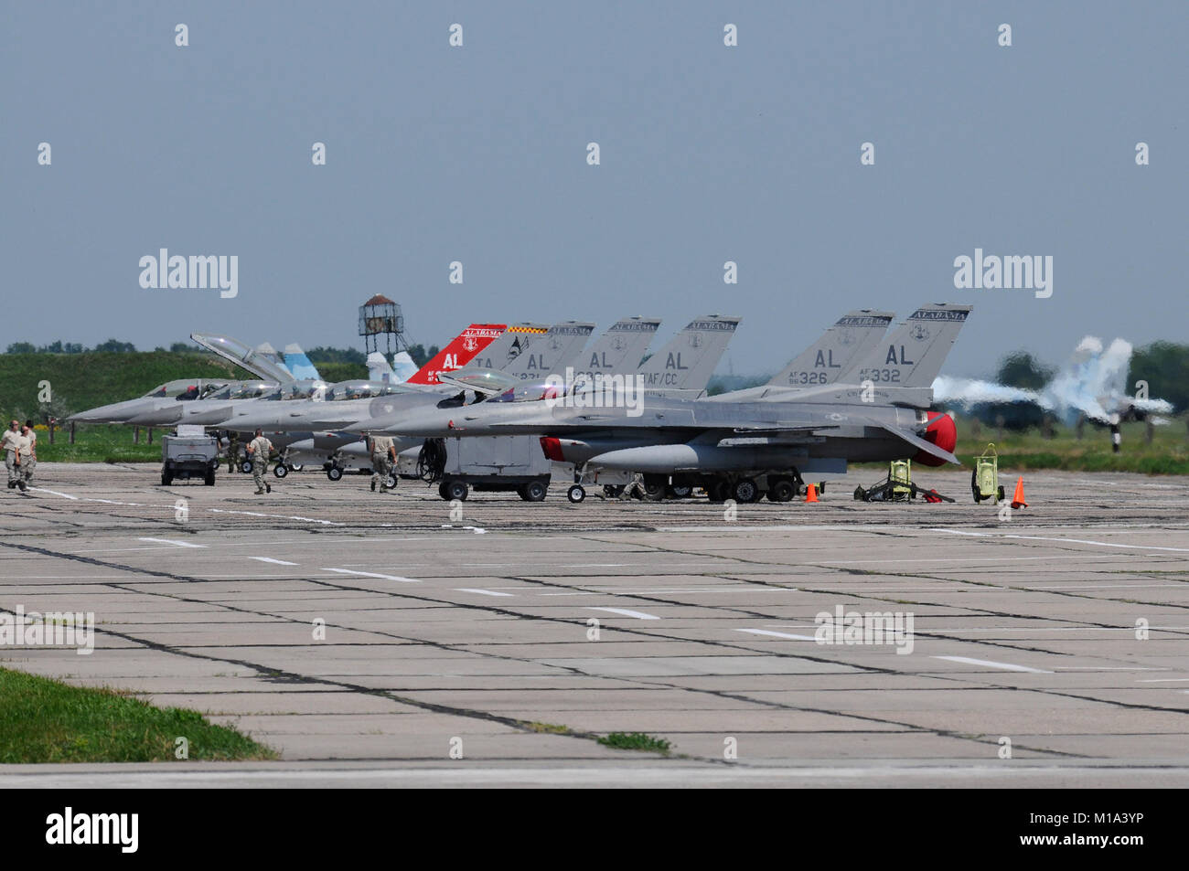 110719-Z-VM449-051 Lined-up and ready to go, seven Air National Guard F-16C/Ds sit on the ramp at Mirgorod Air Base Ukraine.  .  The Air National Guard is in Ukraine supporting SAFE SKIES 2011, a 2-week multinational flying event preparing Ukraine and Poland to better protect their airspace during the 2012 EUROPCUP.   (U.S. Air Force Photo by Tech. Sgt. Charles Vaughn, 144 FW/PA / Released) Stock Photo