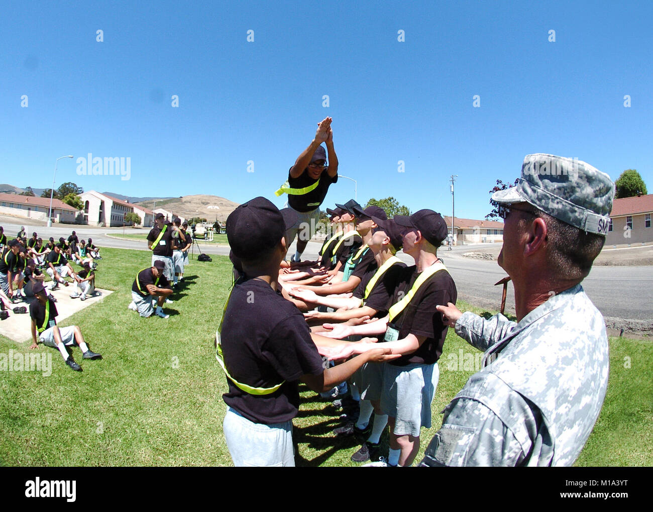 A young student flies off a platform and is caught by other candidates of the California Army National Guard’s Grizzly Academy July 19 at Camp San Luis Obispo during Day 2 of a two-week confidence building session. (US Army photo/SPC EDDIE SIGUENZA) Stock Photo