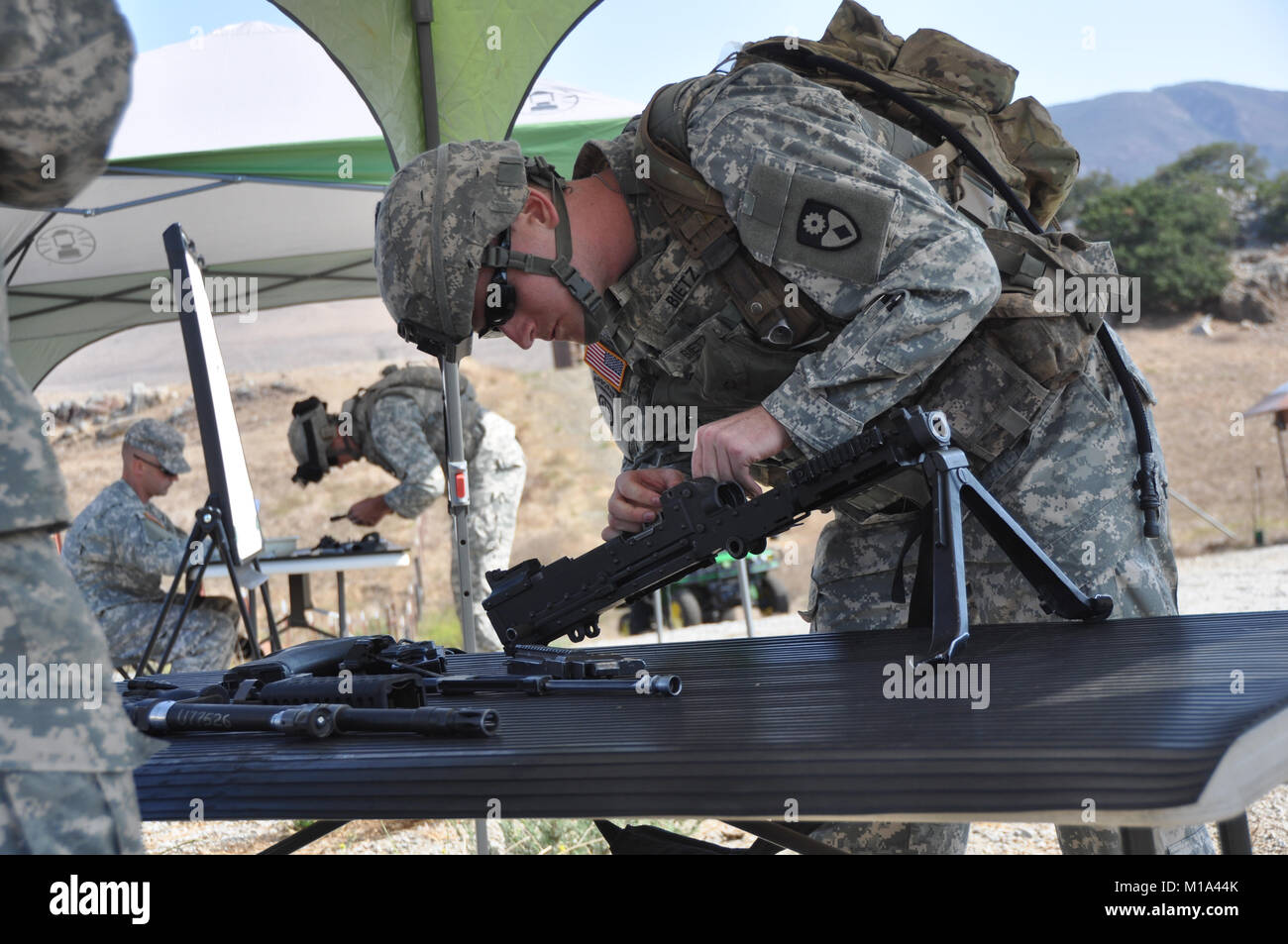 110912-Z-DH635-014 Spc. Daniel Bietz of the 49th Military Police Brigade out of Fairfield, Calif., took apart and reassembled an M249 light machine gun for time during the Best Warrior’s Competition at Camp San Luis Obispo, Calif., Sept. 12, 2011. On the first day of the week-long event, the nine competitors conducted an Army Physical Fitness Test, performed weapons knowledge tasks at five stations, and ran lanes which consisted of calling in reports, reacting to direct and indirect fire, performing first aid, engaging the enemy, clearing a building and calling in a medevac. (Army National Gua Stock Photo