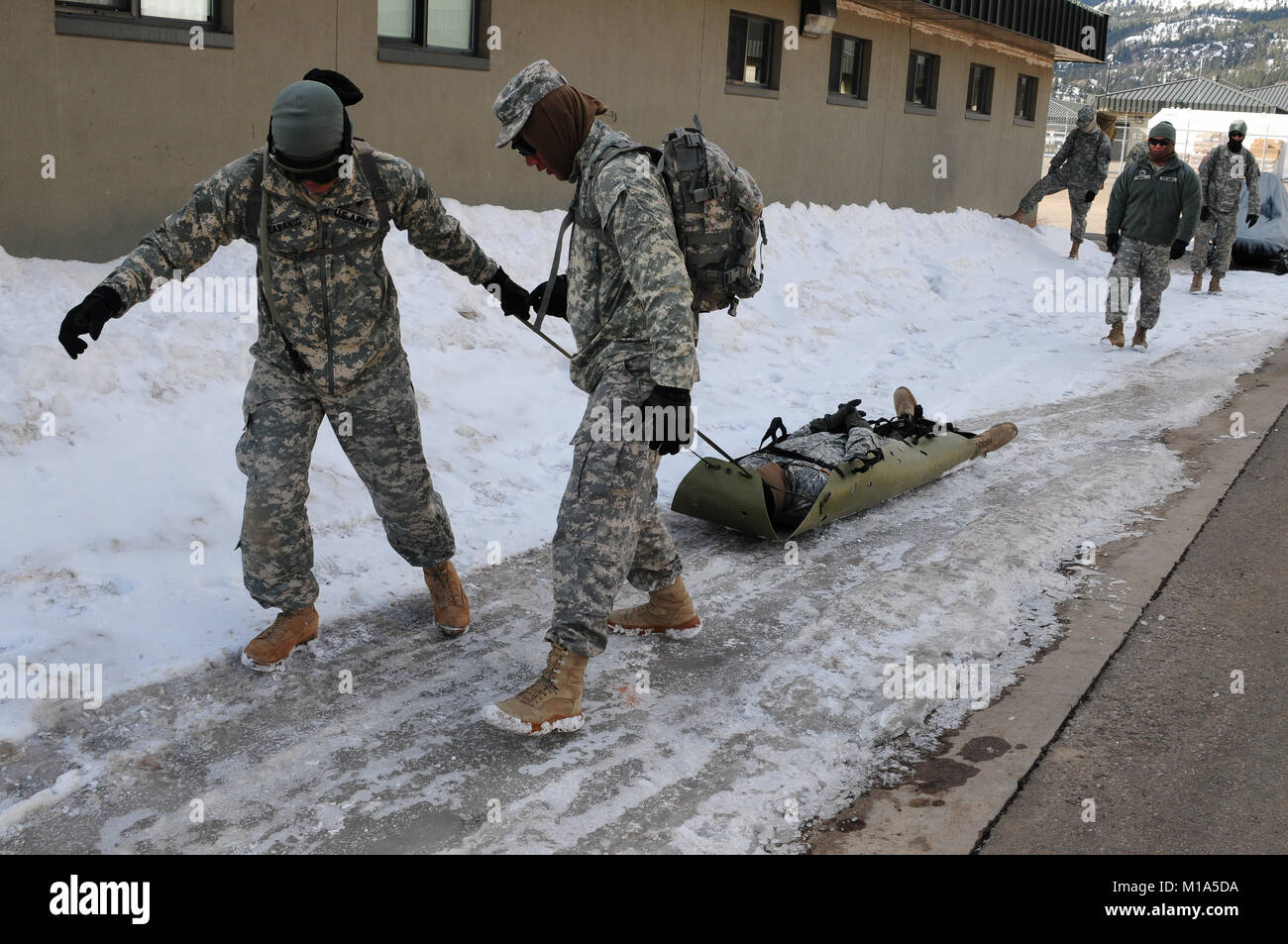 120214-Z-WM549-003 Pulling a portable skid are Spc. Jan Cabanig, left, and Pfc. Uriel Gutierrez of the 1-160th Infantry Battalion, 79th Infantry Brigade Combat Team, California Army National Guard, during preparation for Operation Red Snow Feb. 14 at the Marine Corps Mountain Warfare Training Center in Pickel Meadows, Calif. (Army National Guard photo/Spc. Eddie Siguenza) Stock Photo