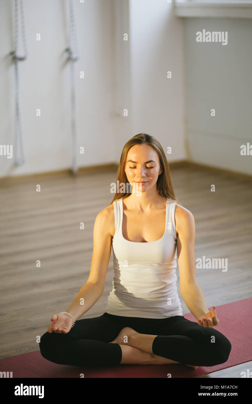 Young woman meditates while practicing yoga Stock Photo - Alamy