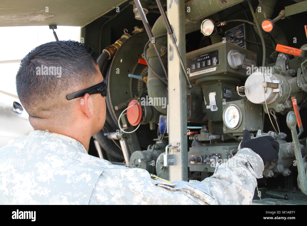 Spc. Abraham Jimenez of 1st Battalion, 126th Aviation Regiment, California Army National Guard, monitors fuel being pumped into a LUH-72 Lakota helicopter Aug. 1 at Middletown Helibase, Middleton California. (U.S. Army National Guard photo/Staff Sgt. Eddie Siguenza) Stock Photo