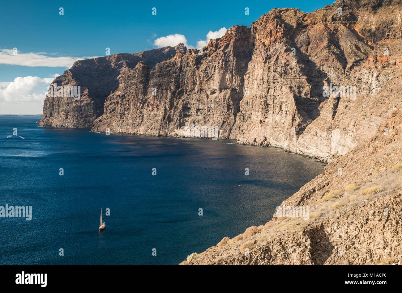 The huge cliffs of mafic lava flows cut by numerous dykes at Los Gigantes, Tenerife, Canary Islands, Spain Stock Photo