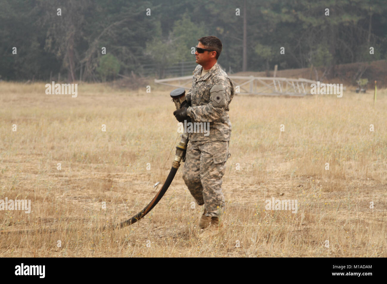 Pfc. John Aleschus, a fueler with the California Army National Guard, runs a hose to a CH-47 Chinook Aug. 18. (U.S. Army National Guard photo/Staff Sgt. Eddie Siguenza) Stock Photo